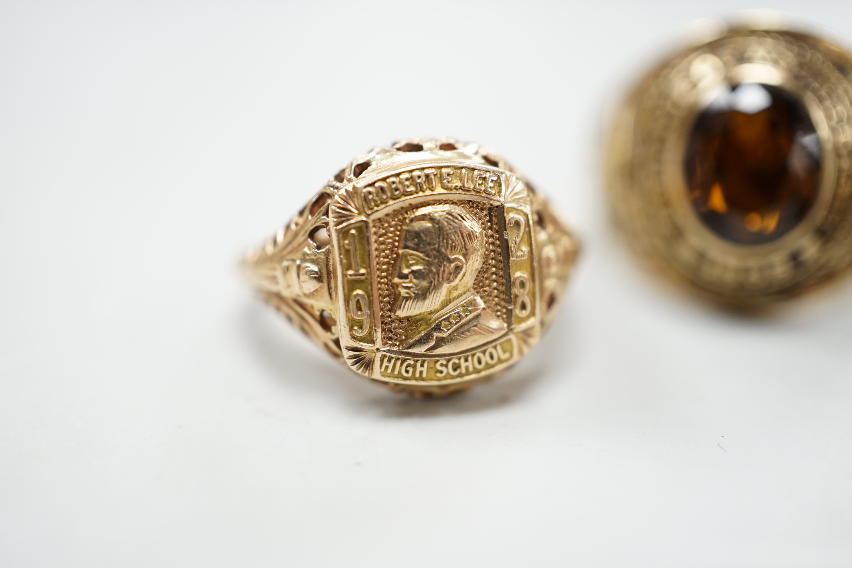 Three assorted American 10k dress rings, two set with gems, one signed John Roberts, gross weight 18.9 grams.